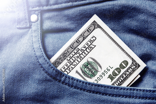 Pocket money background. Hundred dollar bill. Money in blue jeans trousers. Cash in trousers.