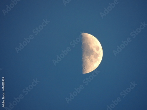 The moon on a blue background (sky). Macro photography with a zoom lens.