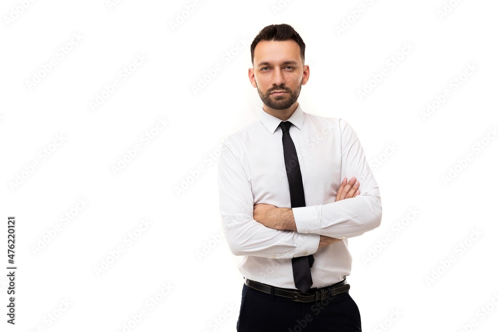 serious man in a business shirt and a black tie with crossed arms on his chest on a white background, Concept of Management and and Human Resource Management in Business serious man in a business shirt and a black tie with crossed arms on his chest on a white background, Concept of Management and and Human Resource Management in Business