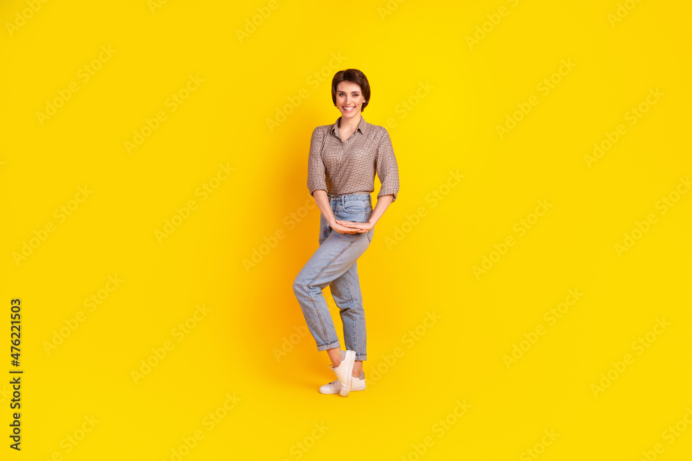 Full size photo of young attractive woman good mood wear casual outfit isolated over yellow color background