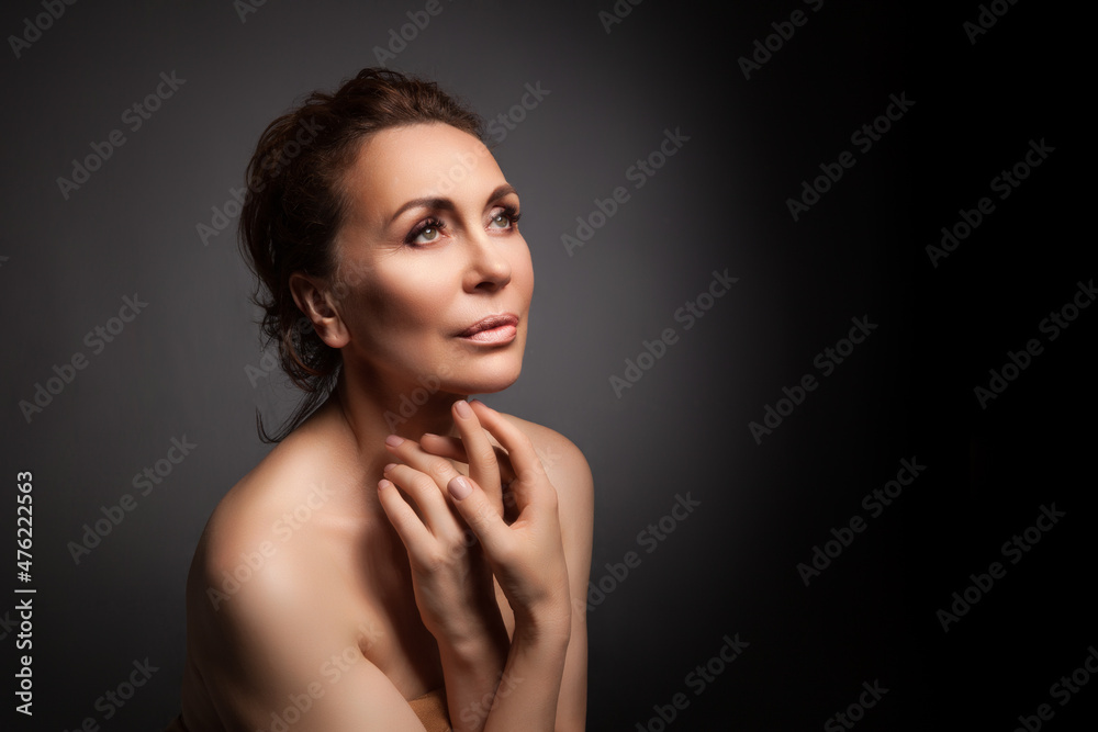 portrait of a sensual fifty year old woman on grey studio background portrait of a sensual fifty year old woman on grey studio background