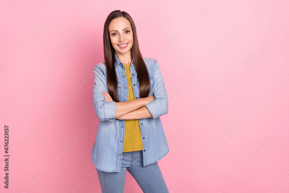 Photo of brunette cool mature lady crossed palms wear jeans jacket isolated on pastel pink color background Photo of brunette cool mature lady crossed palms wear jeans jacket isolated on pastel pink color background