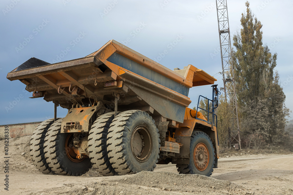 Large mining dump truck. Transport industry. Extraction of stone in an open pit Large mining dump truck. Transport industry. Extraction of stone in an open pit