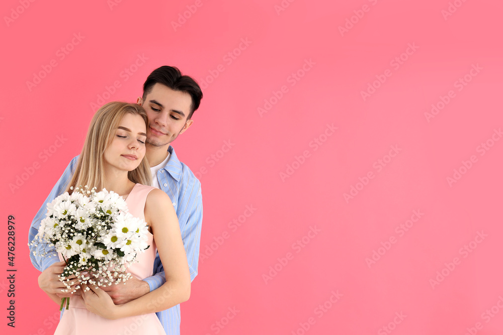 Cute couple with bouquet on pink background Cute couple with bouquet on pink background