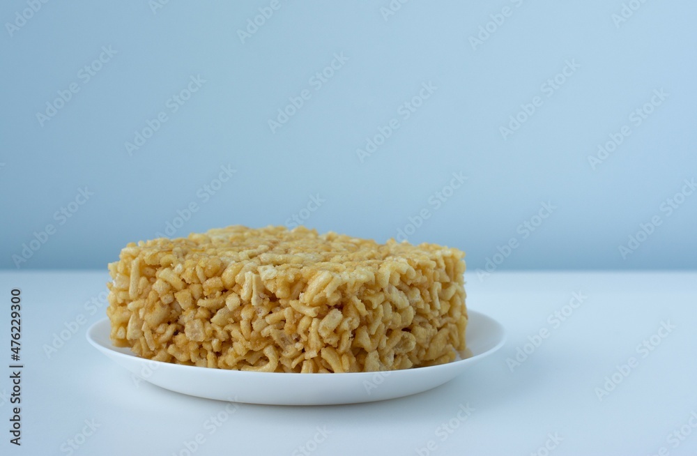 Chak chak with honey in a white plate on blue and white. National dish of Tatars and Bashkirs. Oriental sweets Chak chak with honey in a white plate on blue and white. National dish of Tatars and Bashkirs. Oriental sweets