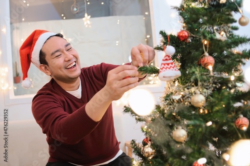 santa claus decorating christmas tree