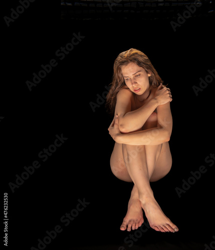 Beautiful professional model posing naked in a tasteful and artistic manner.