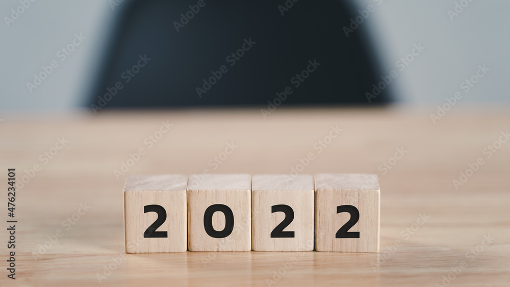 start to year 2022. wooden cube block with 2022 year text on wood table with copy space. happy new years concept. start to year 2022. wooden cube block with 2022 year text on wood table with copy space. happy new years concept.