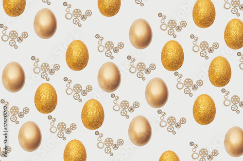 Creative Easter pattern made with golden , glitter egg and gearwheel .Flat lay minimal background. photo