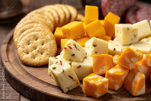Cheese platter with sausage and crackers photo
