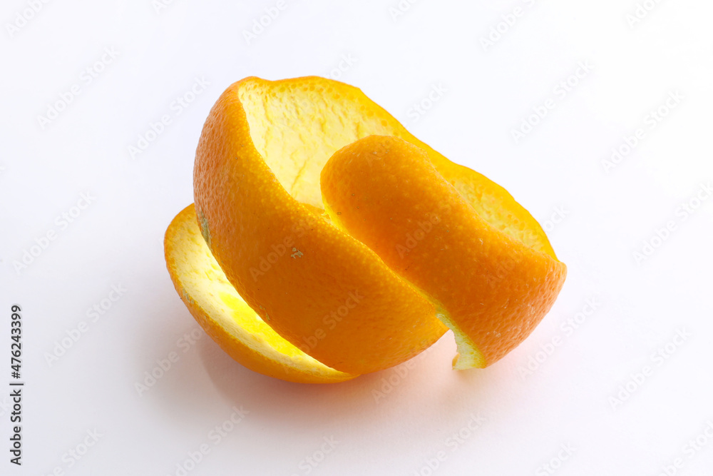 Orange peel on a white background. Spiral cut orange peel. Orange peel from an orange.
