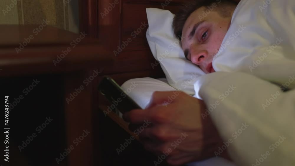 Young guy sitting on social networks before bed. Young guy sitting on social networks before bed.