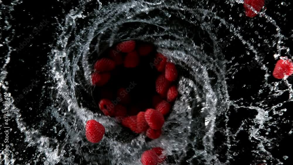 Super slow motion of raspberries flying in the air. Macro shot. Filmed on high speed cinema camera, 1000 fps.