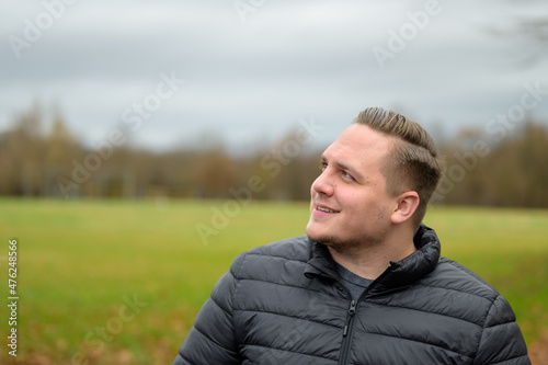 Young man smiling in fascination as he looks to the side