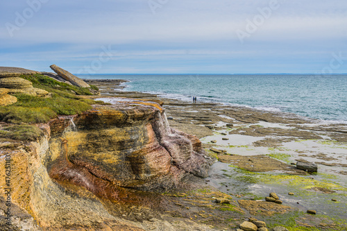 The Cap Ferré waterfall, a small waterfall rich in iron (thus the rusty color), near Havre St Pierre, in Cote Nord region of Quebec, Canada photo