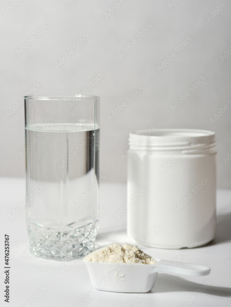 collagen peptides powder in a white unbranded container and glass with water. collagen for beautiful skin and healthy joints. natural supplement for beauty care. collagen peptides powder in a white unbranded container and glass with water. collagen for beautiful skin and healthy joints. natural supplement for beauty care.