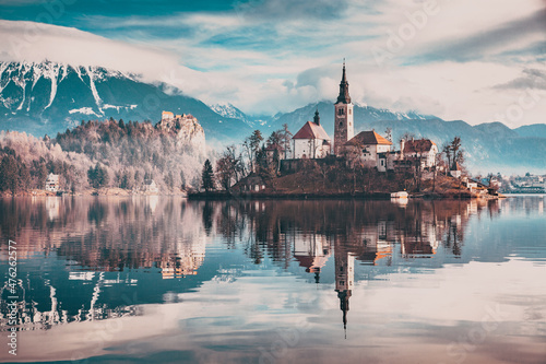 amazing panorama of Lake Bled Blejsko Jezero on a foggy morning with the Pilgrimage Church of the Assumption of Maria on a small island and Bled Castle and Julian Alps in backgroud photo