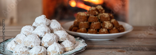 Christmas Greek dessert. Traditional homemade melomakarono and kourabies on a wooden table photo