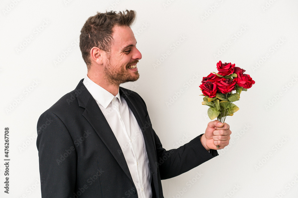 Young caucasian man holding bouquet of flowers isolated on white background Young caucasian man holding bouquet of flowers isolated on white background
