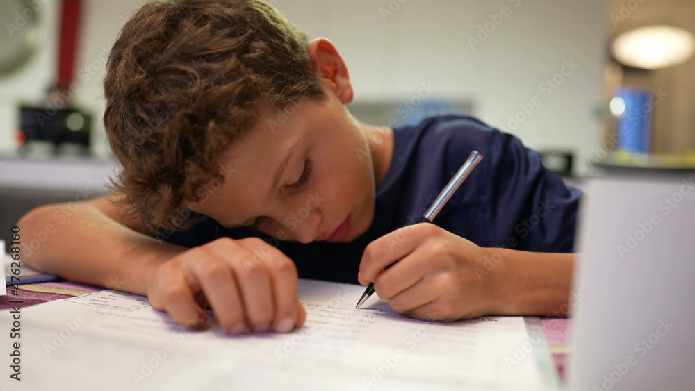 Young boy doing homework after school. Kid preparing for exam Young boy doing homework after school. Kid preparing for exam