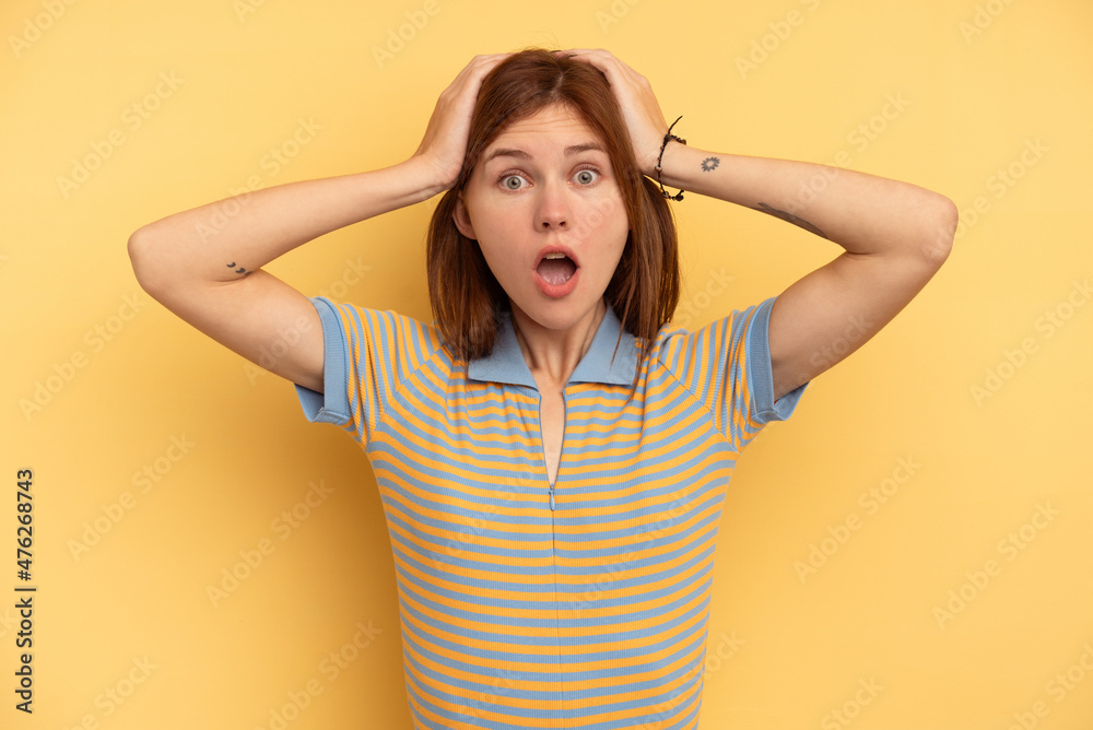 Young English woman isolated on yellow background surprised and shocked. Young English woman isolated on yellow background surprised and shocked.