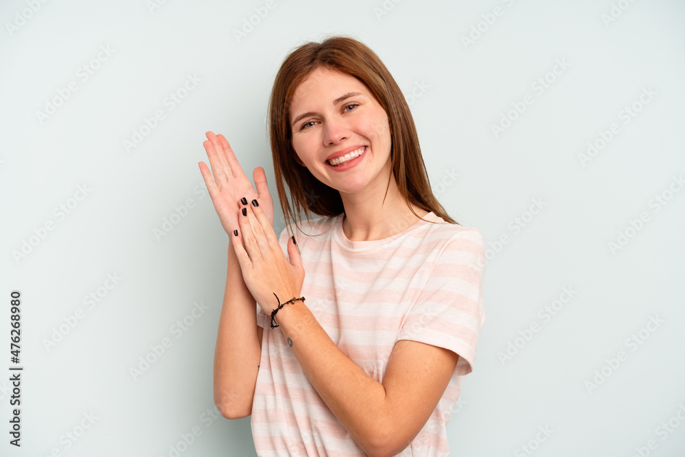 Young English woman isolated on blue background feeling energetic and comfortable, rubbing hands confident. Young English woman isolated on blue background feeling energetic and comfortable, rubbing hands confident.