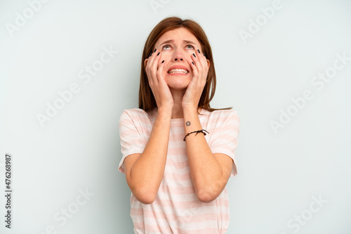 Young English woman isolated on blue background whining and crying disconsolately.