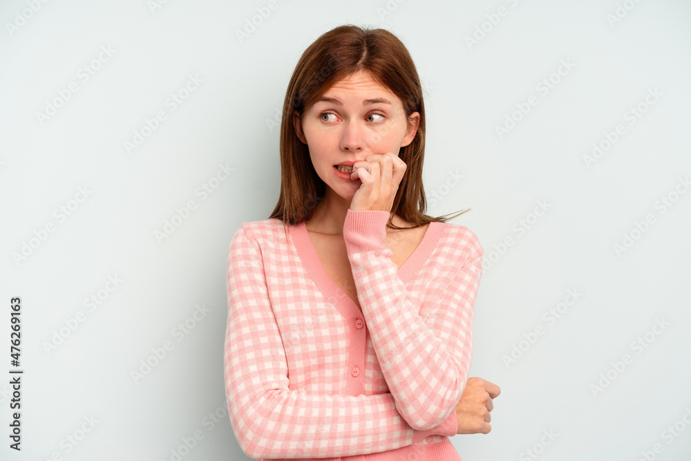 Young English woman isolated on blue background biting fingernails, nervous and very anxious. Young English woman isolated on blue background biting fingernails, nervous and very anxious.