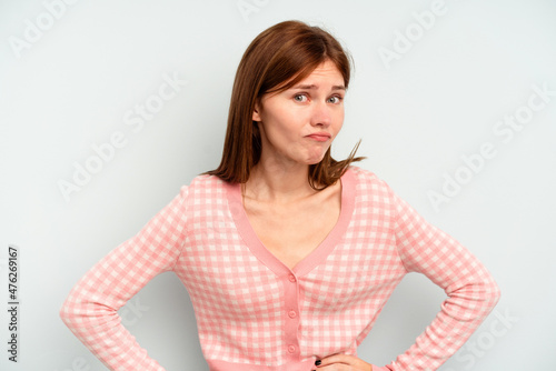 Young English woman isolated on blue background confused, feels doubtful and unsure. © Asier