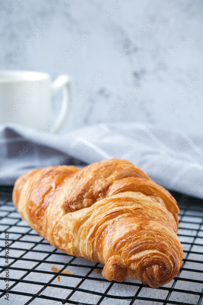 Croissant on baking rack with white background Croissant on baking rack with white background