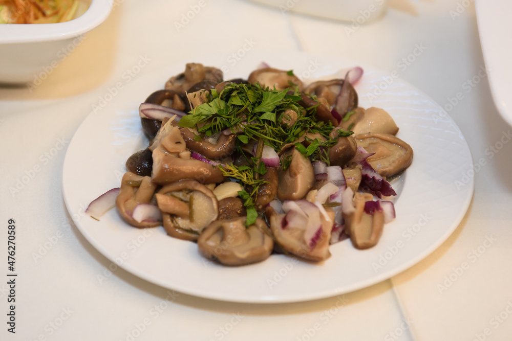 Mushroom salad on the table. A table with food and alcohol served with dishes for guests. Mushroom salad on the table. A table with food and alcohol served with dishes for guests.