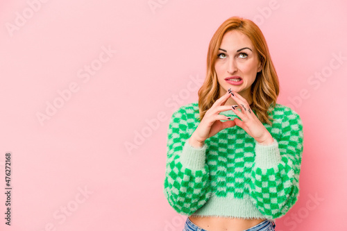 Young caucasian woman isolated on pink background making up plan in mind, setting up an idea.