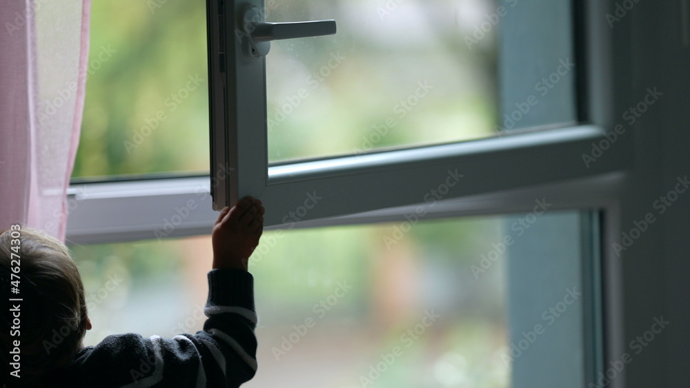 Child closing window. Toddler closes window Child closing window. Toddler closes window