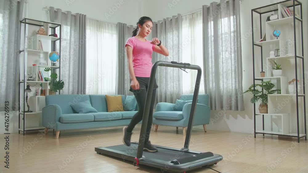 Asian Woman Looking Smart Watch And Training On Walking Or Running Treadmill At Home
Asian Woman Looking Smart Watch And Training On Walking Or Running Treadmill At Home