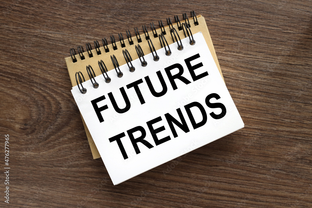 two notepads on a wooden table. FUTURE TRENDS two notepads on a wooden table. FUTURE TRENDS