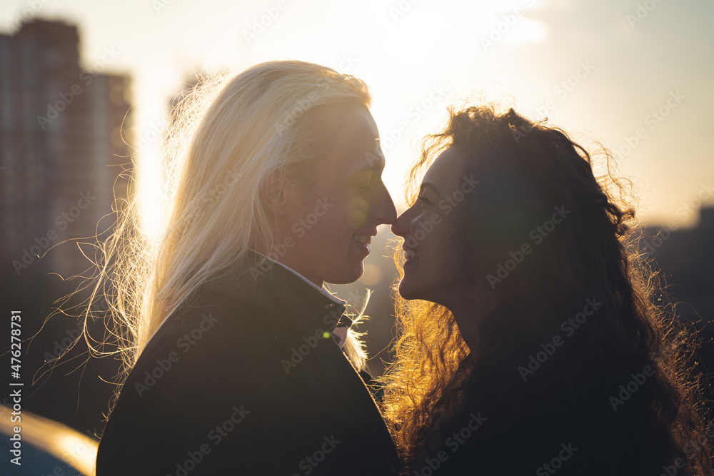 Silhouette of Romantic young couple on sunset. Feelings, love and attraction concept Silhouette of Romantic young couple on sunset. Feelings, love and attraction concept