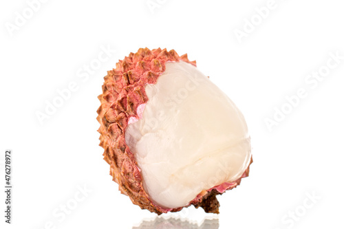 One ripe organic litchi fruit, close-up, isolated on white.