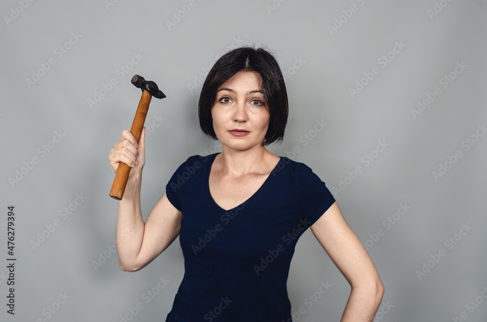 Hammer in hand of woman master. Construction and repair concept. Hammer in hand of woman master. Construction and repair concept.