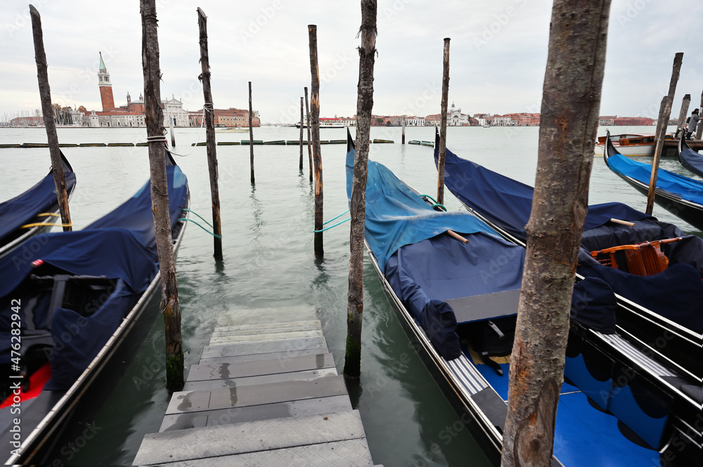 Empty gondolas swing on water, Venice, Italy
