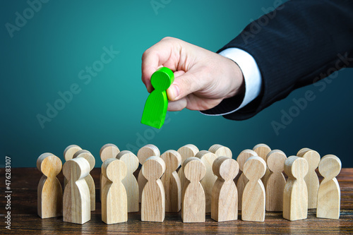 Businessman appoints a leader for the group. Distribution of management in the company. Leading positions, specialized training of managers. Structuring company employees, assigning responsibilities. photo