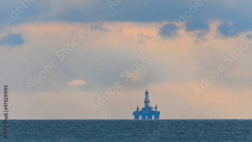 Deepwater oil platform on the horizon at sea photo