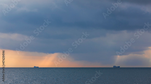 Two ships on the horizon in cloudy weather