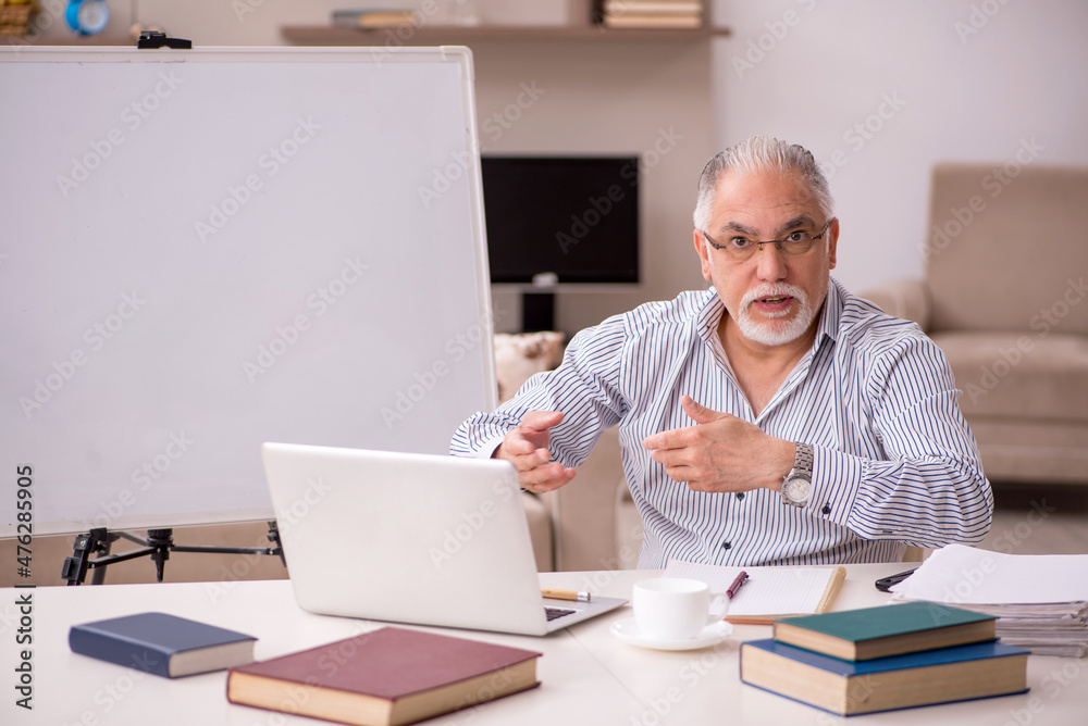 Old male employee working from home during pandemic Old male employee working from home during pandemic