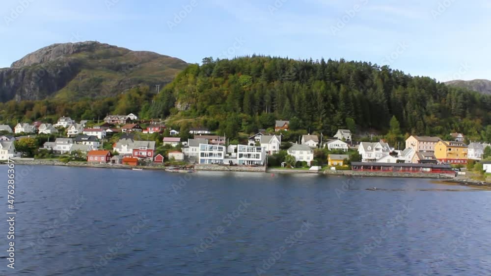 Traveling by boat through a typical Norwegian village Traveling by boat through a typical Norwegian village