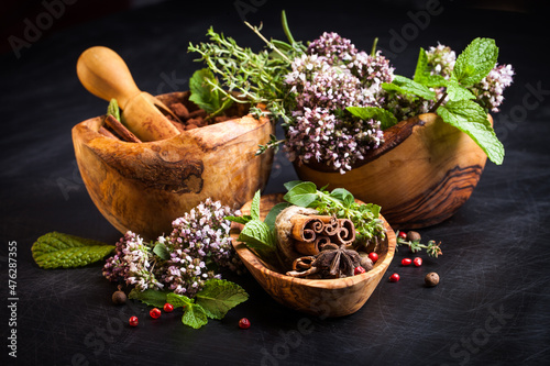 Fresh herb oregano flowers in a wooden bowl