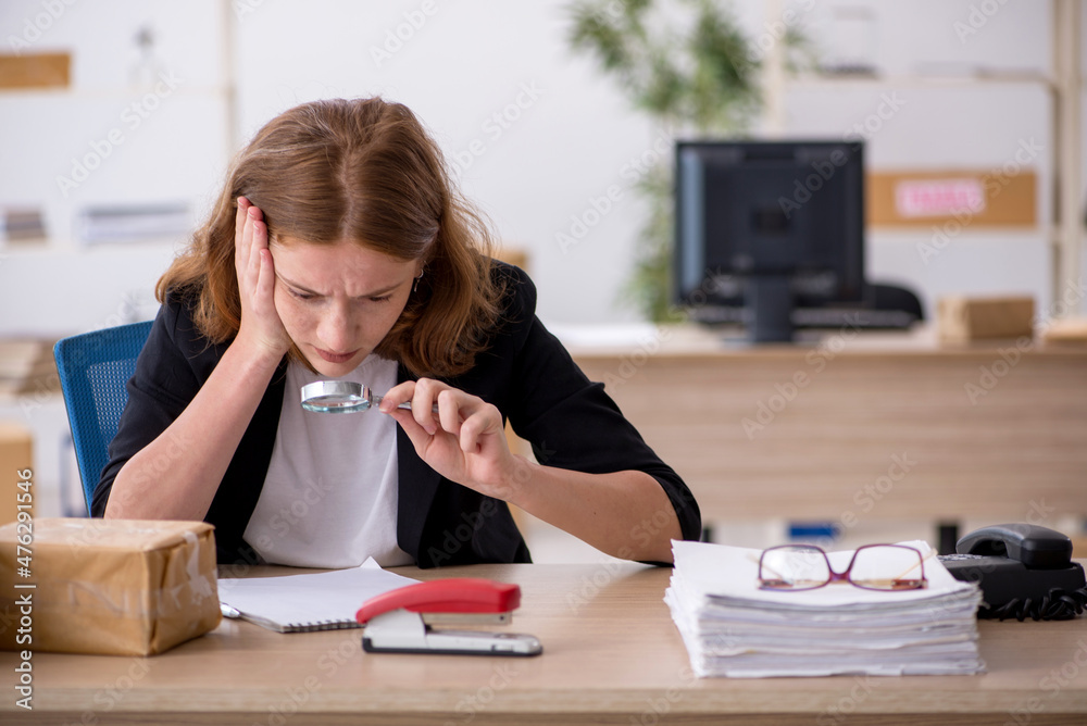 Young woman working in box delivery service Young woman working in box delivery service