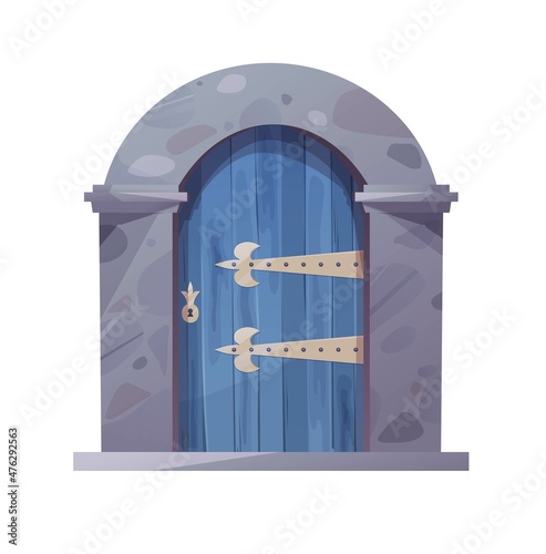 Antique medieval wooden door with metal round handle and lined with stones. Gothic entrance, gate in a castle, church or house.