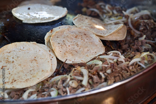 Beef tacos with onion, cilantro and salsa. Street tacos. Mexican tacos. Street sale of tacos.