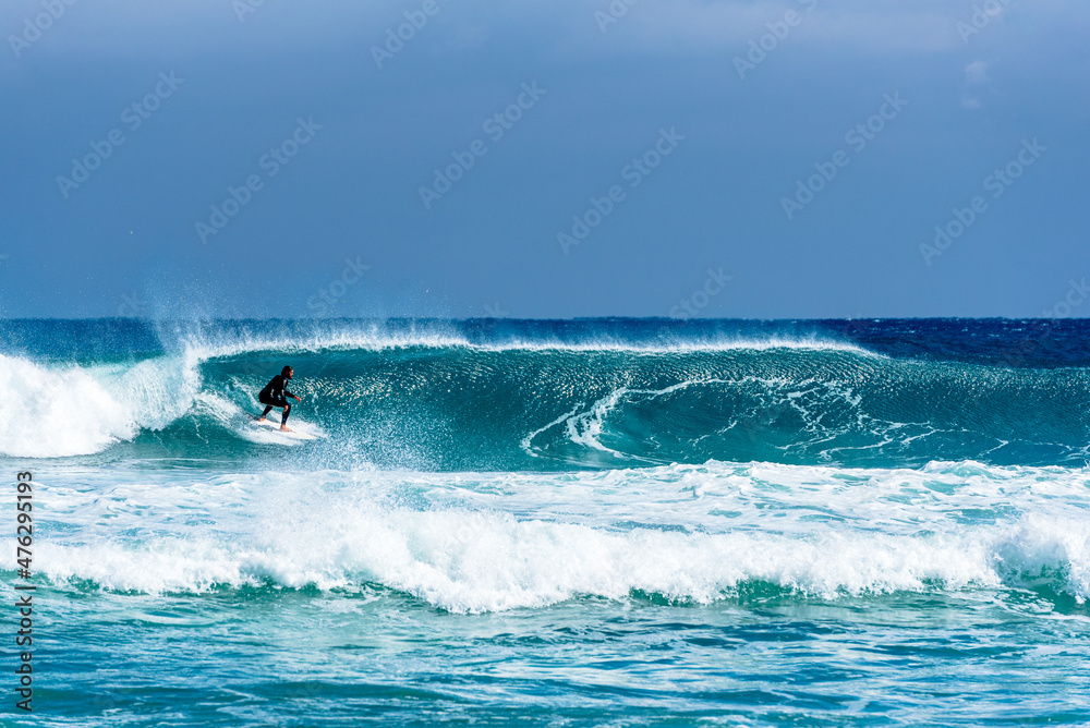 Surfer man surfing on wave in ocean 