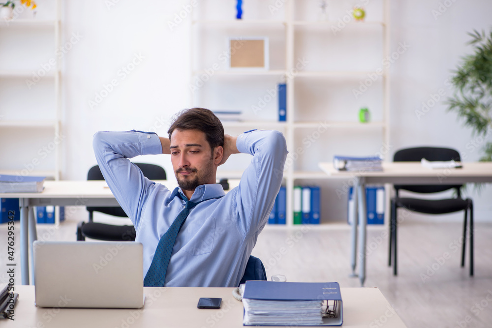 Young male employee working in the office